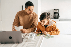 Dad with son next to computer